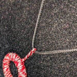 A new simple twine necklace hung on string with a chain clasp